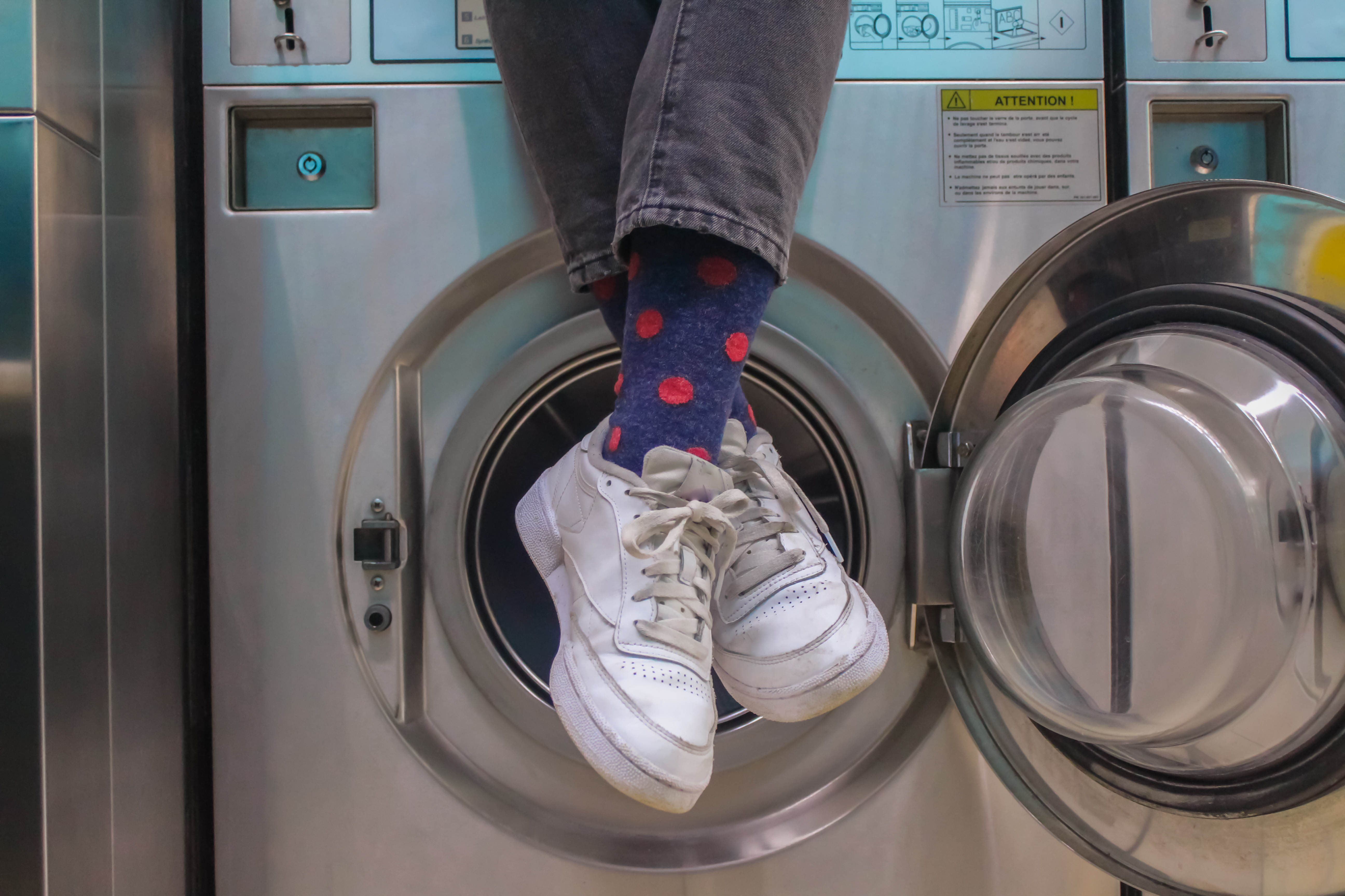 A pair of socks next to a washing machine